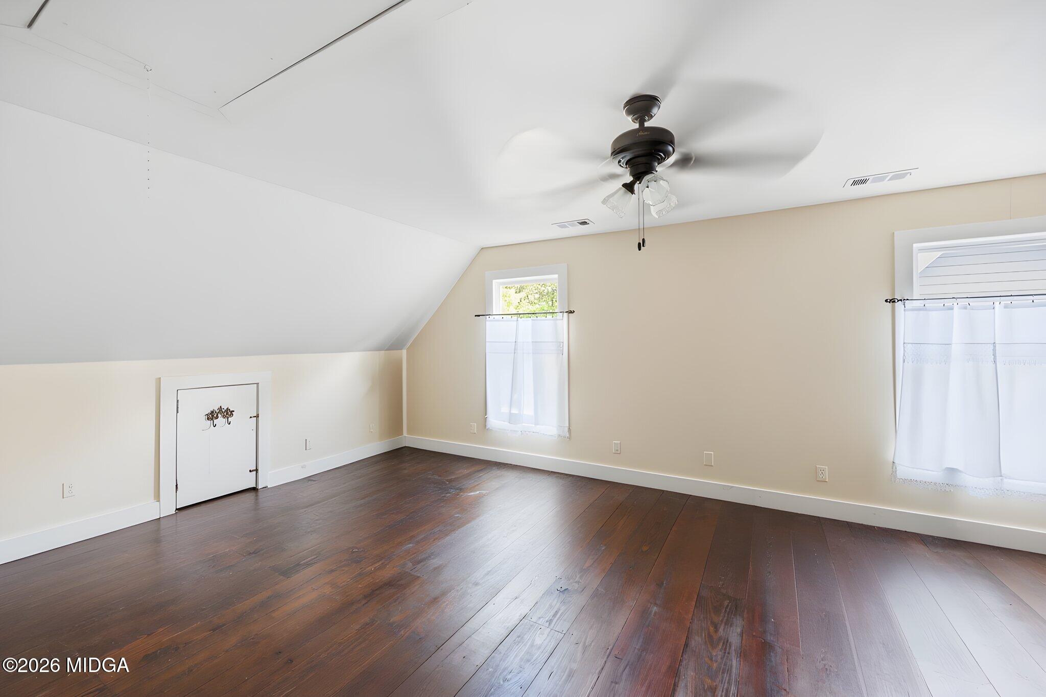 4686 Johnstonville Road Forsyth, GA 31029 - Photo 24 of 34 an empty room with wooden floor and windows