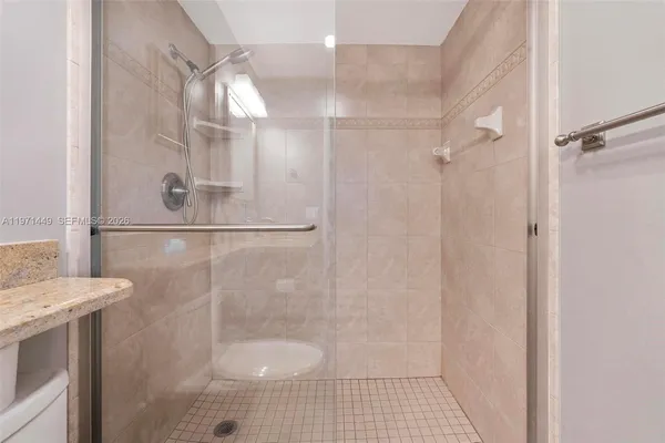 a bathroom with a shower and a sink