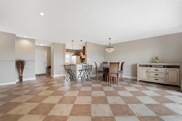 a view of a dining room with furniture and chandelier