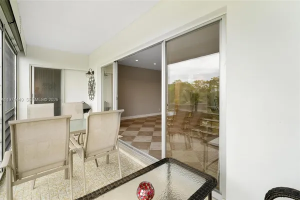 a view of a dining room with a table and chairs