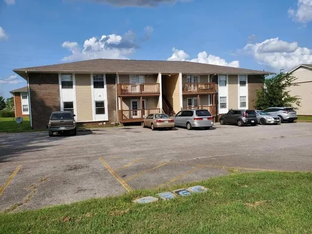 a view of a car parked in front of a brick building