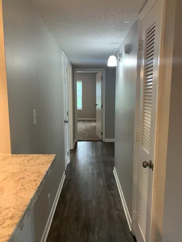 a view of hallway with wooden floor