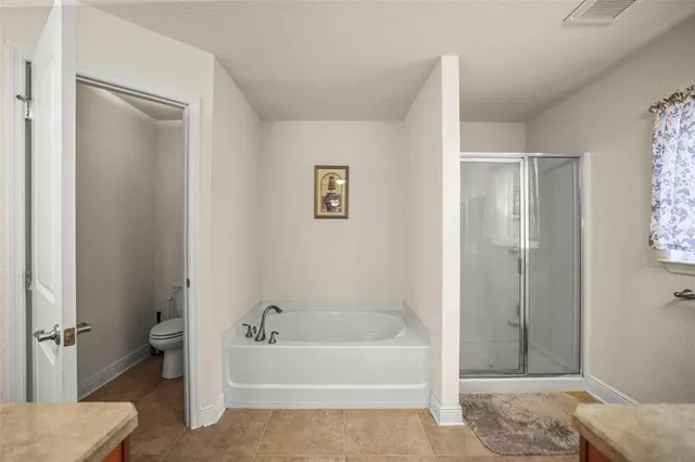 a white toilet sitting next to a bathroom sink