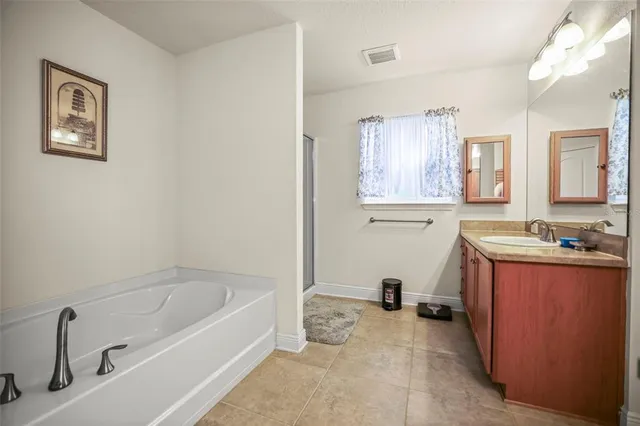 a en suite bathroom with a granite countertop sink and a toilet