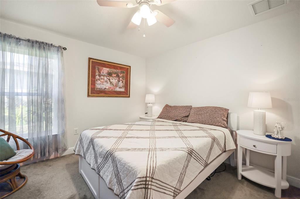 190 Rusk Circle Spring Hill, FL 34606 - Photo 19 of 35 a bedroom with a bed and a chair