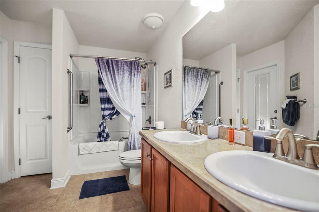 190 Rusk Circle Spring Hill, FL 34606 - Photo 21 of 35 a en suite bathroom with a granite countertop sink and a toilet