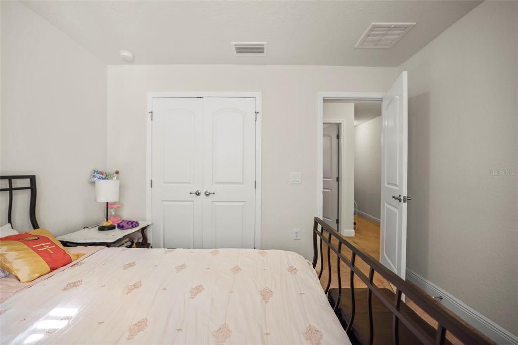 190 Rusk Circle Spring Hill, FL 34606 - Photo 27 of 35 a bedroom with a bed and wooden floor