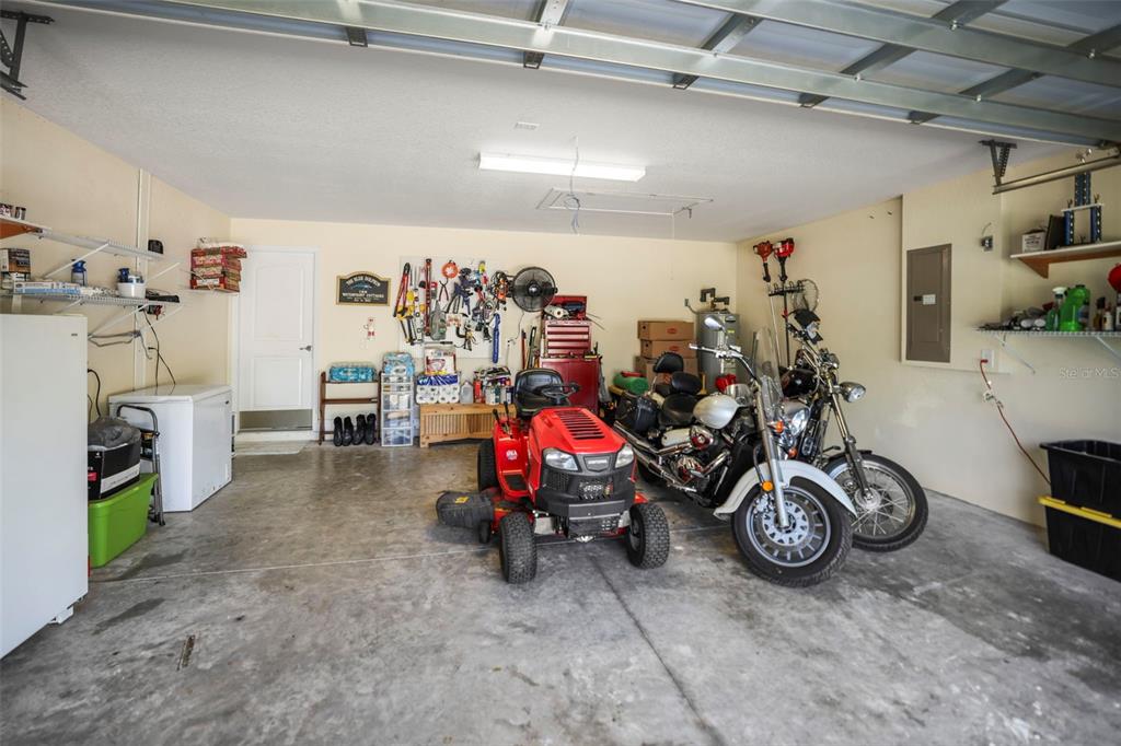 190 Rusk Circle Spring Hill, FL 34606 - Photo 28 of 35 a view of a garage with a bike and a car