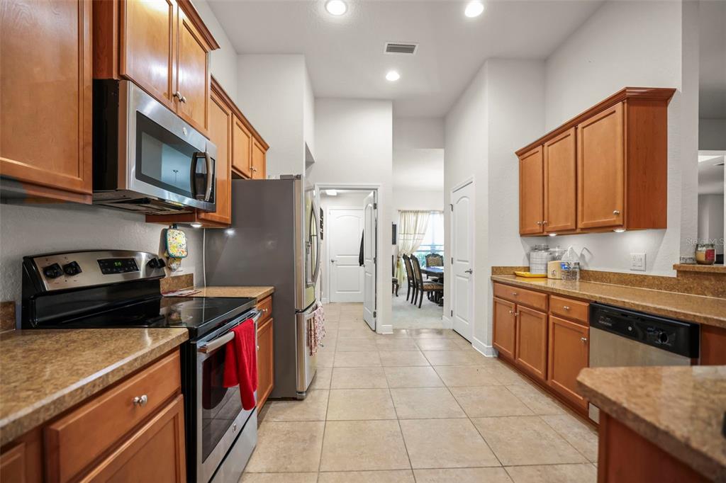190 Rusk Circle Spring Hill, FL 34606 - Photo 33 of 35 a kitchen with stainless steel appliances granite countertop a stove a sink and a refrigerator