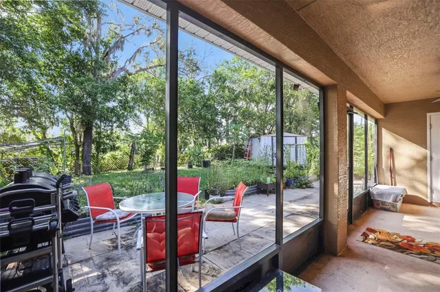 an aerial view of residential houses with outdoor space and trees