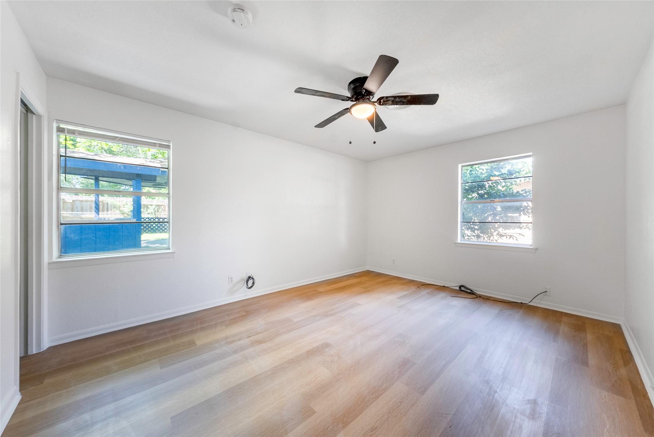807 Country Club Road Georgetown, TX 78628 - Photo 14 of 28 a view of empty room with wooden floor and fan