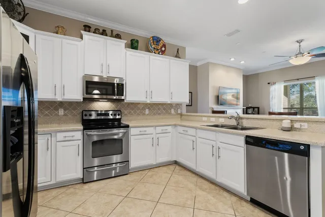 a kitchen with kitchen island a dining table and chairs