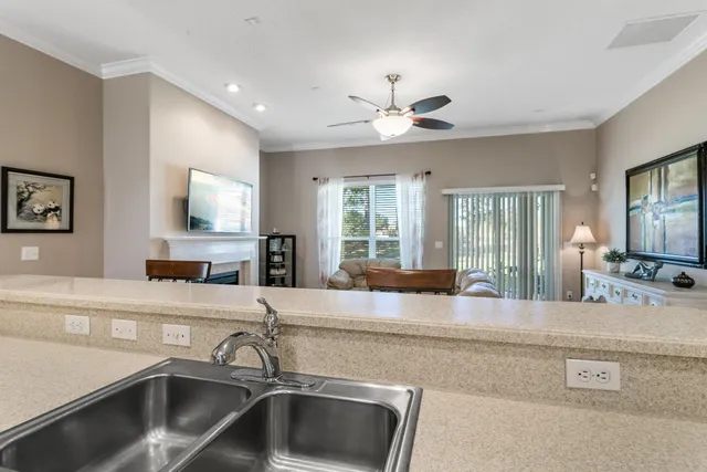 a kitchen with center island a sink stainless steel appliances and cabinets