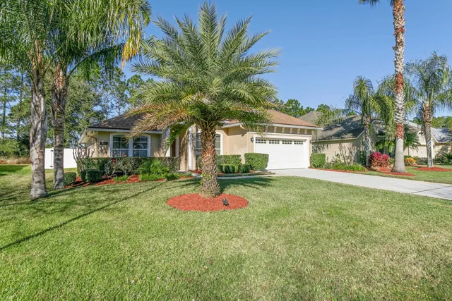 a house with palm tree in front of it