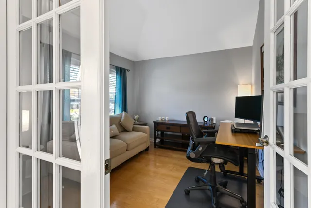 a livingroom with workspace and a couch