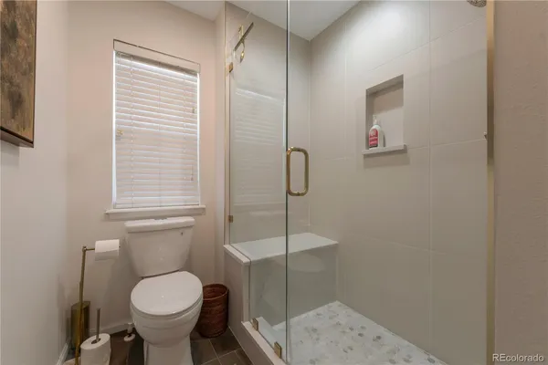 a bathroom with a toilet sink and shower