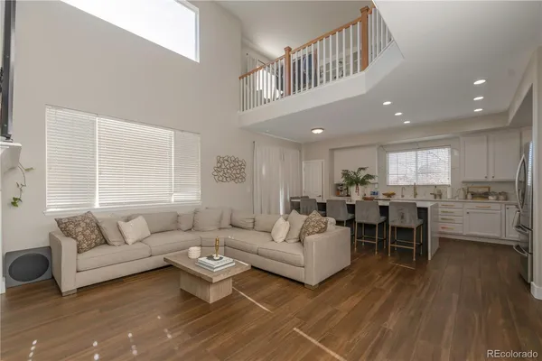 a living room with furniture a wooden floor and a window