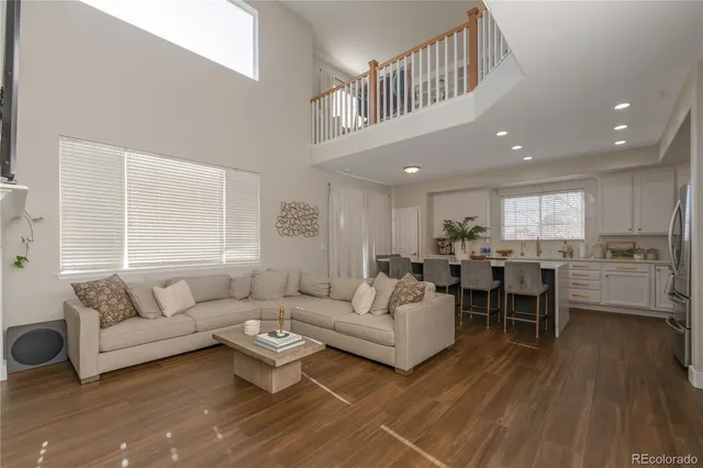 a living room with furniture a wooden floor and a window