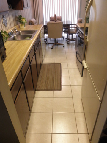 725 West Huntington Commons Road, Unit 419 Mount Prospect, IL 60056 - Photo 13 of 20 a view of a kitchen with dining table and chairs