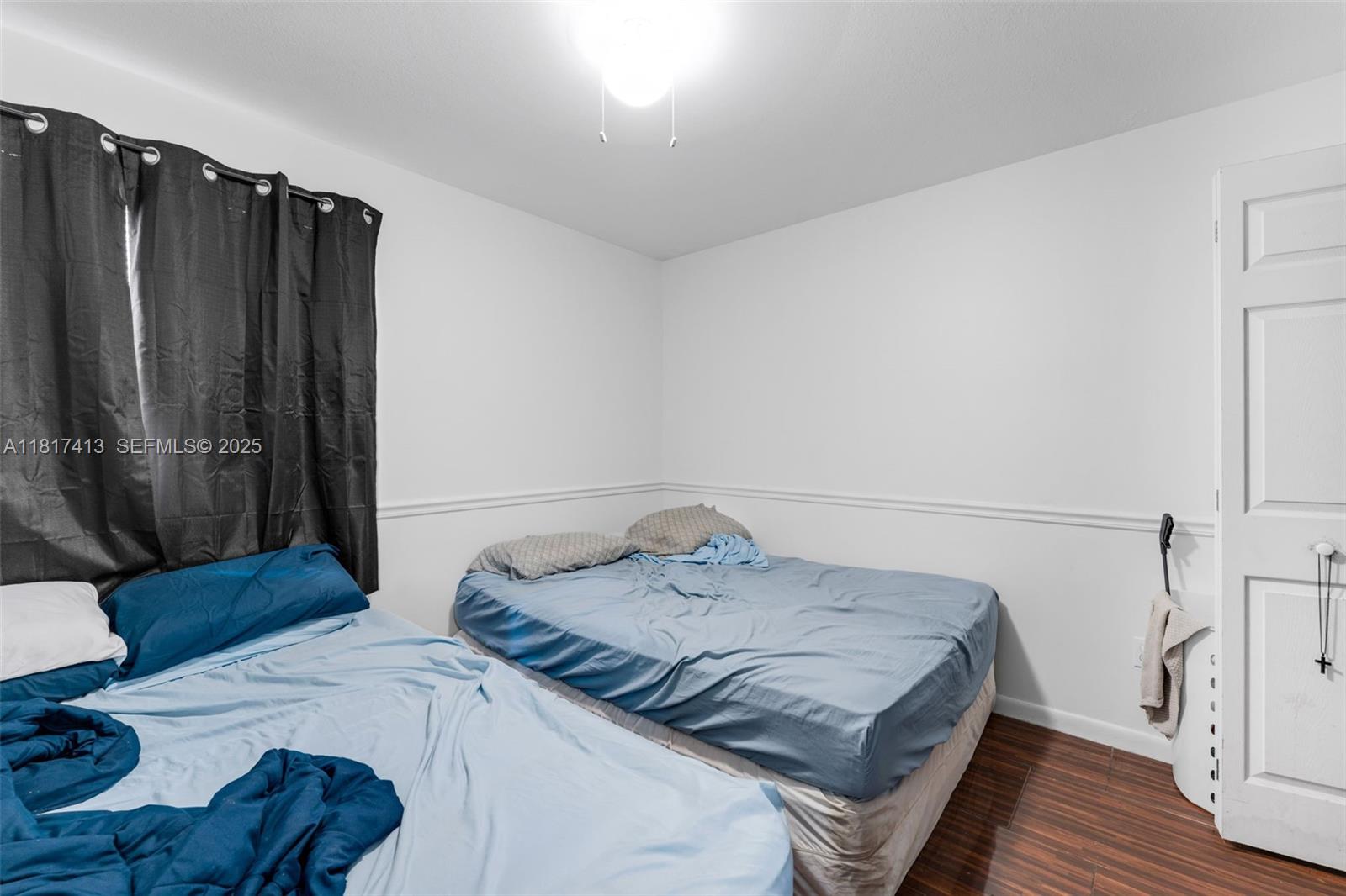 16040 Southwest 287th Street Homestead, FL 33033 - Photo 12 of 48 a bedroom with a bed and a walk in closet