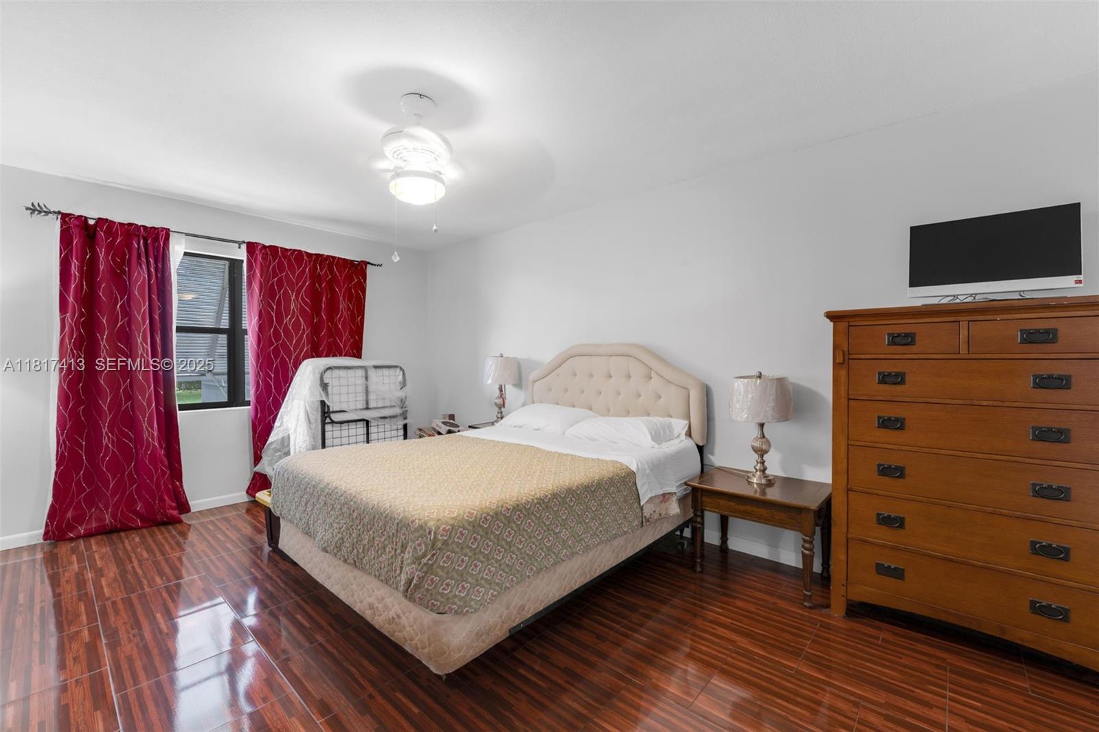 16040 Southwest 287th Street Homestead, FL 33033 - Photo 13 of 48 a bedroom with a bed and a flat screen tv