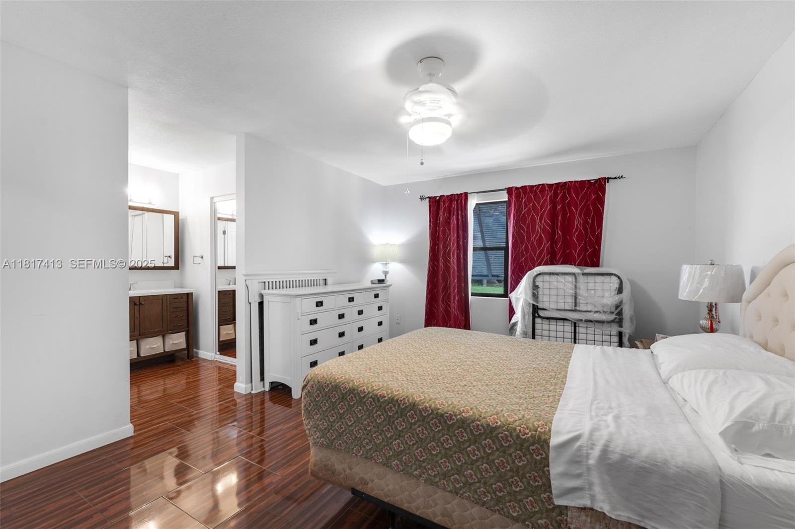 16040 Southwest 287th Street Homestead, FL 33033 - Photo 14 of 48 a bedroom with bed and window