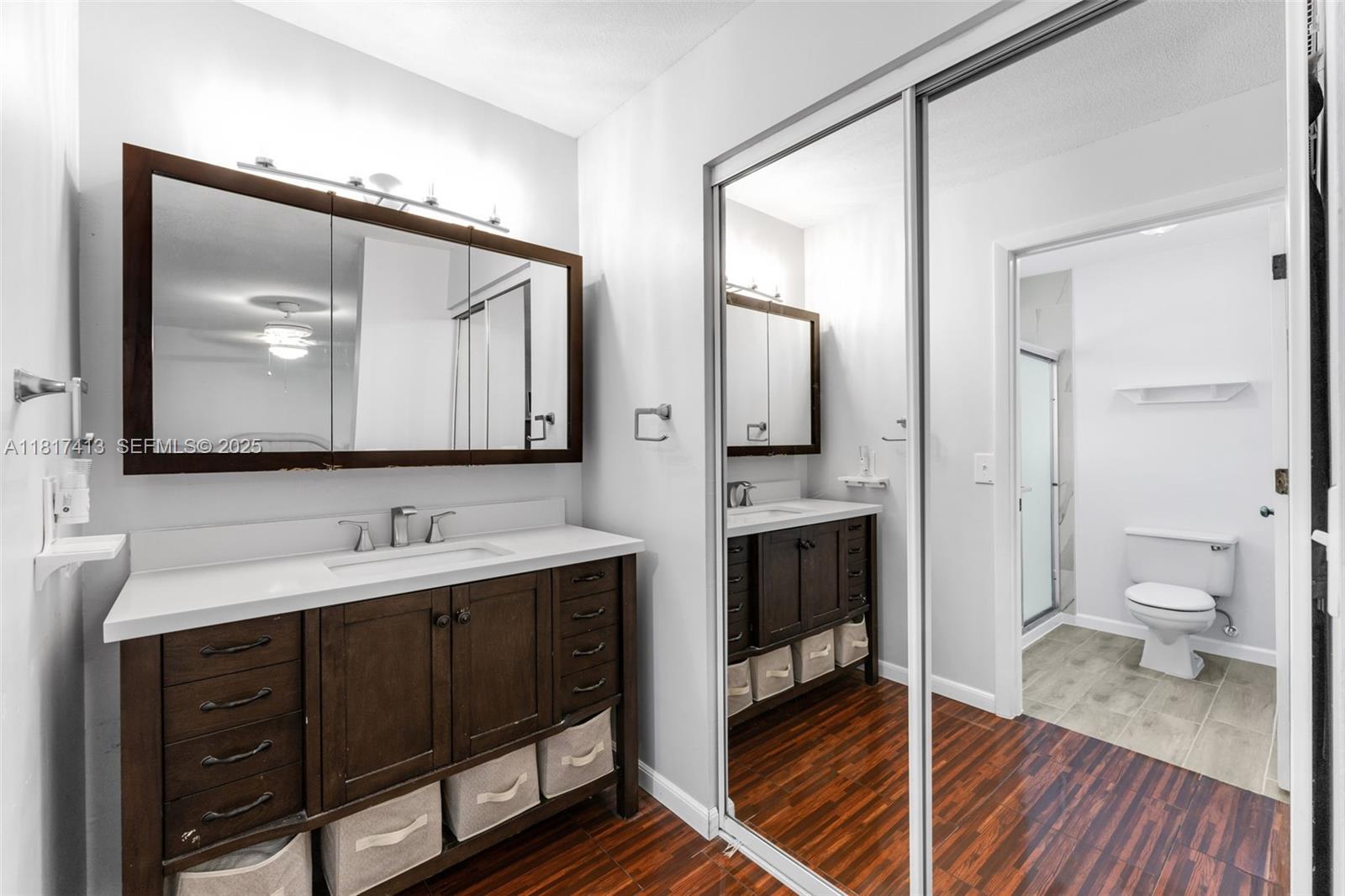 16040 Southwest 287th Street Homestead, FL 33033 - Photo 16 of 48 a en suite bathroom with a toilet sink and mirror