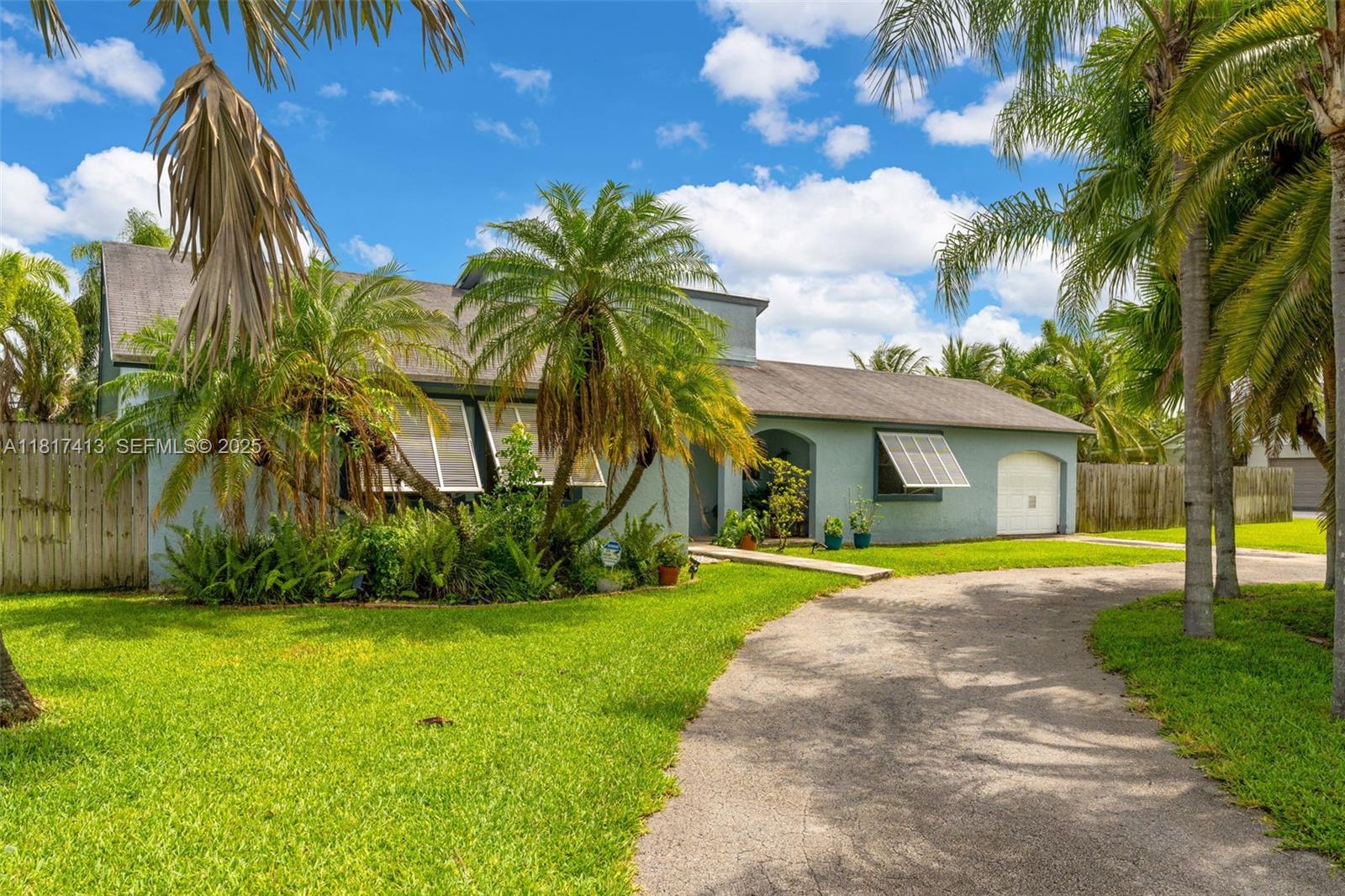 16040 Southwest 287th Street Homestead, FL 33033 - Photo 2 of 48 a front view of house with yard and green space