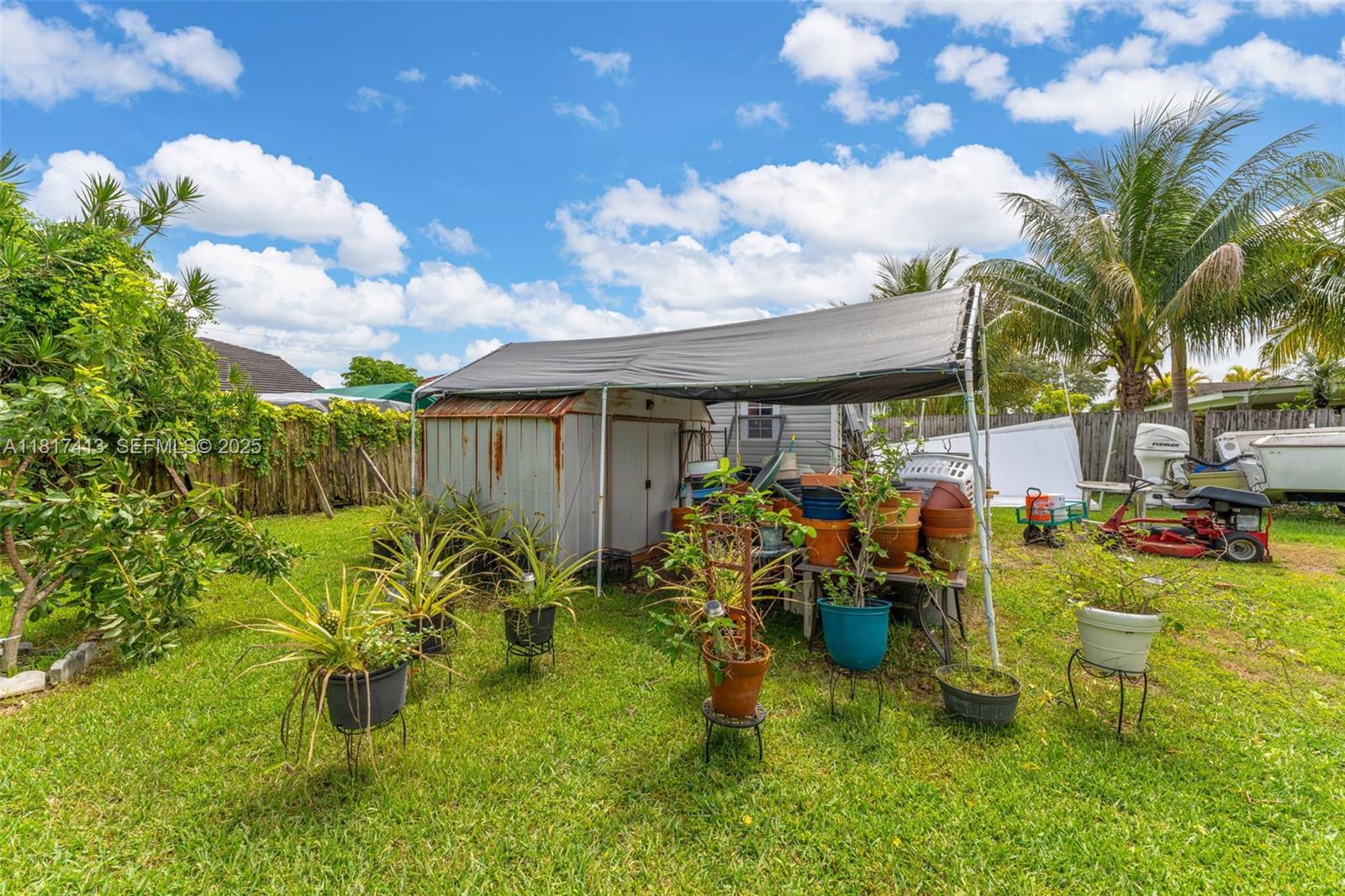 16040 Southwest 287th Street Homestead, FL 33033 - Photo 22 of 48 a view of a backyard with plants and a patio