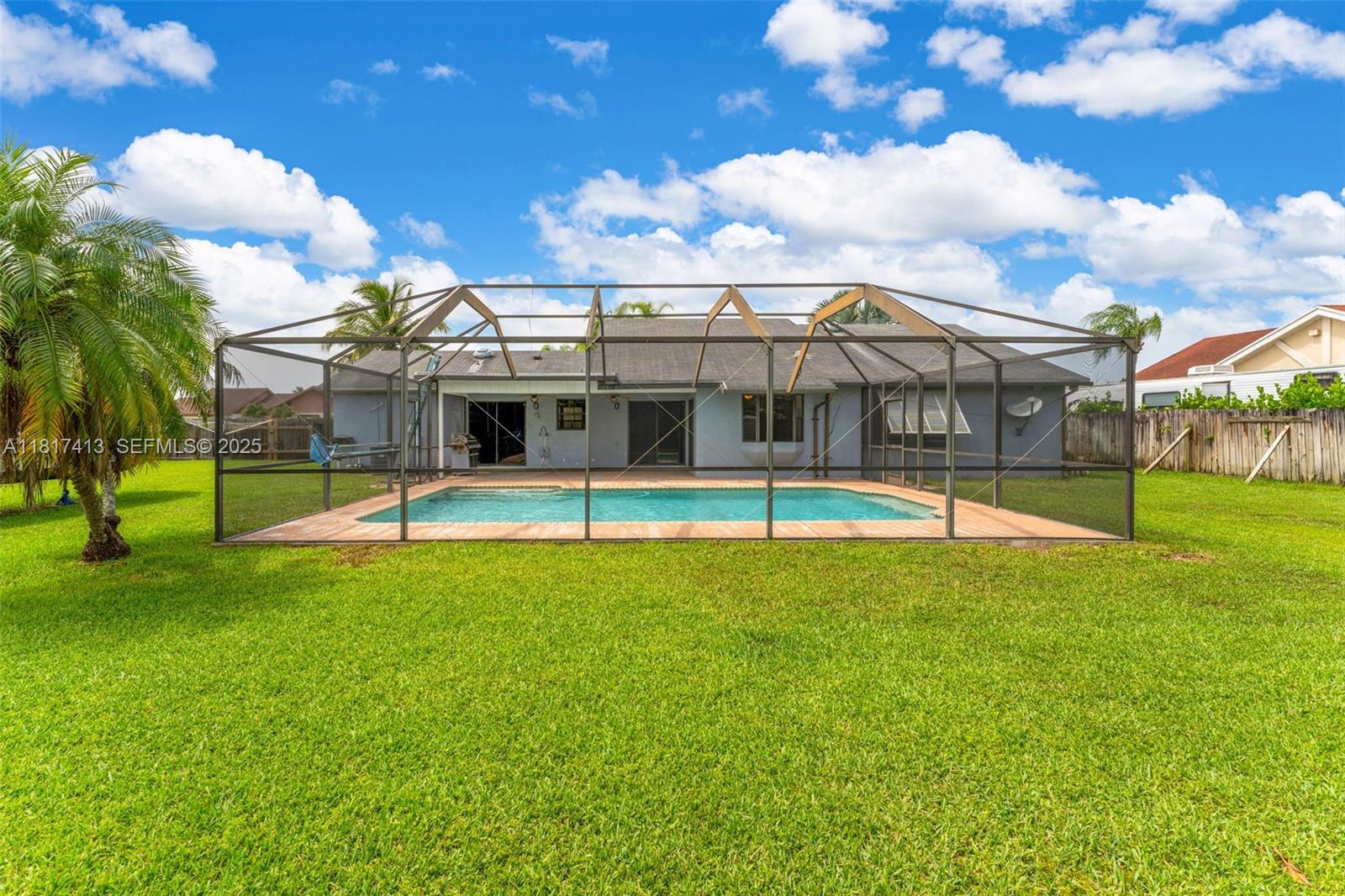 16040 Southwest 287th Street Homestead, FL 33033 - Photo 23 of 48 a view of a swimming pool with a yard