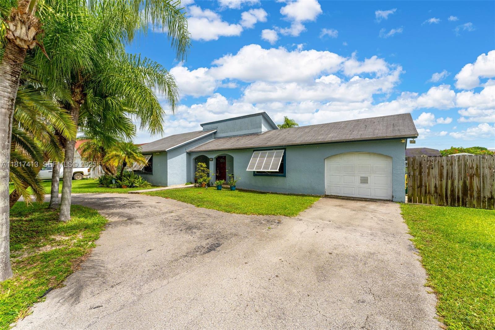 16040 Southwest 287th Street Homestead, FL 33033 - Photo 3 of 48 a front view of a house with a yard and garage