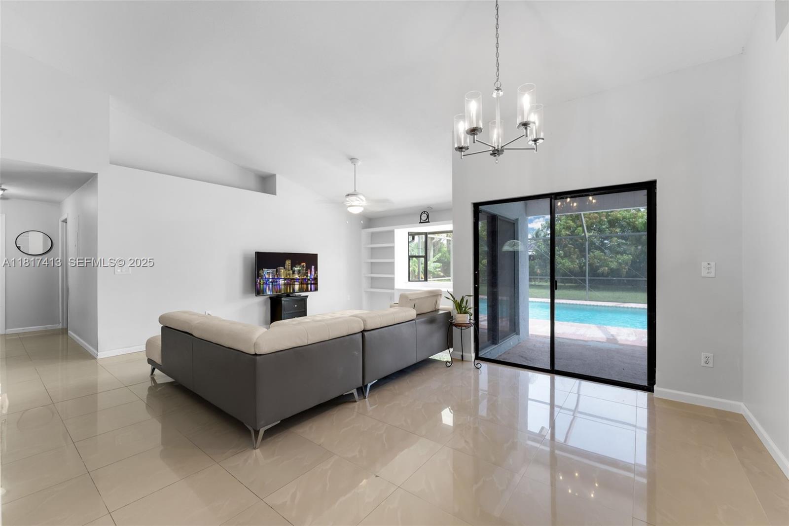 16040 Southwest 287th Street Homestead, FL 33033 - Photo 4 of 48 a living room with furniture and a chandelier