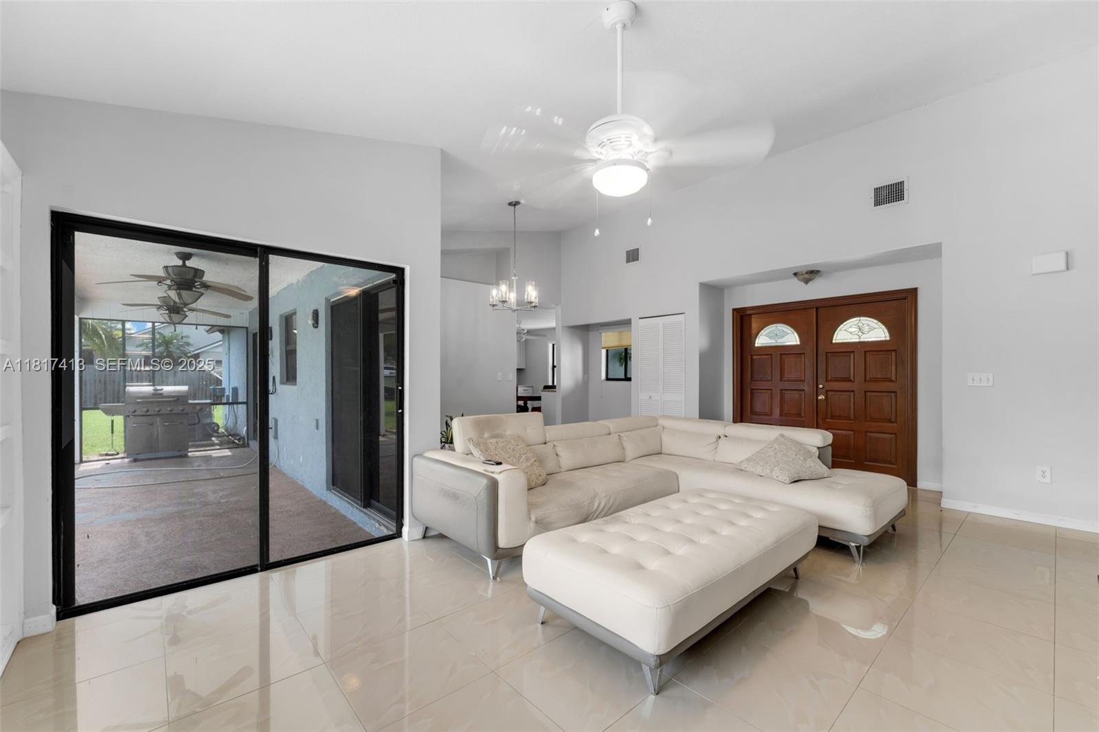 16040 Southwest 287th Street Homestead, FL 33033 - Photo 6 of 48 a living room with furniture and a large window