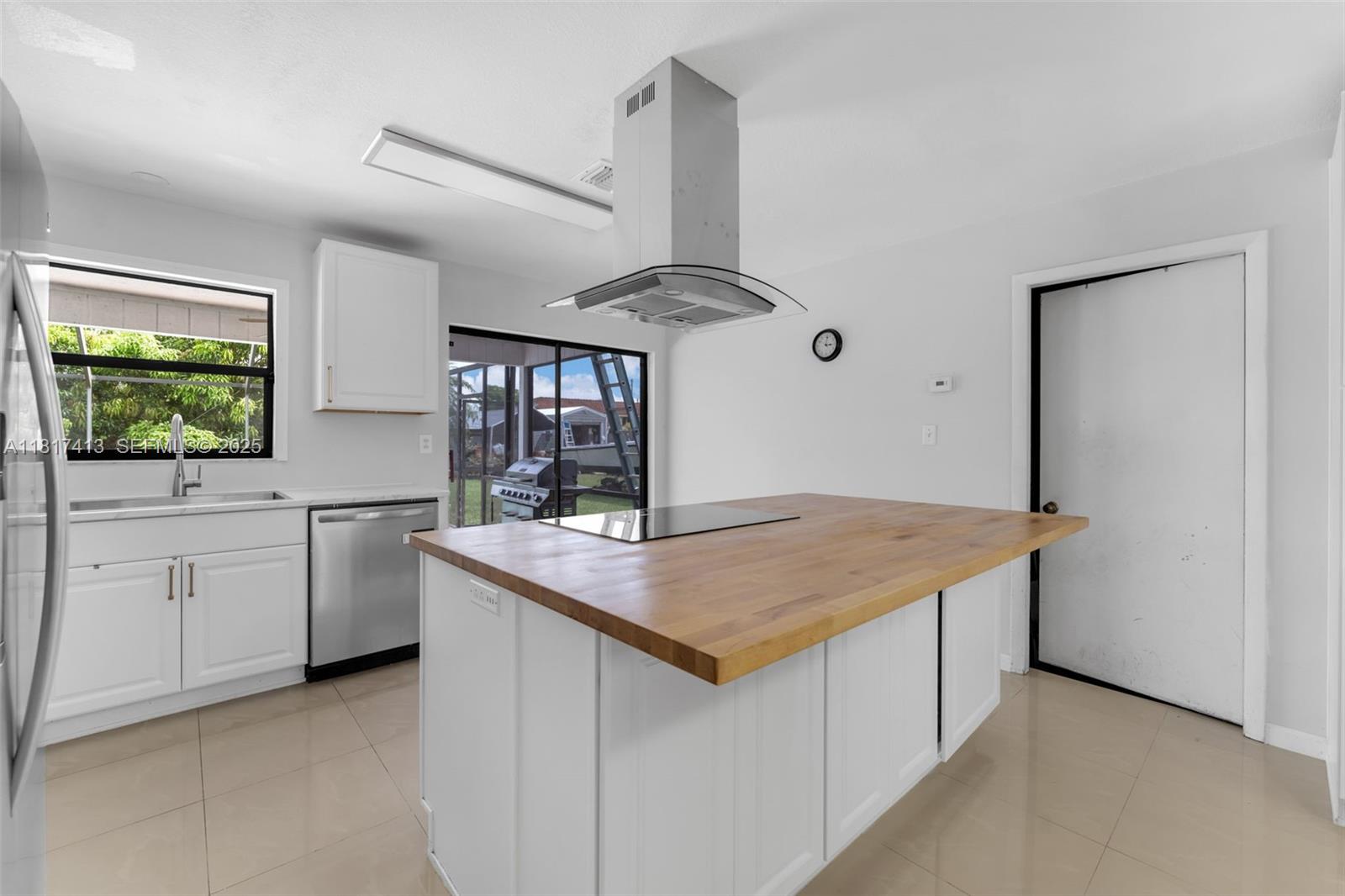 16040 Southwest 287th Street Homestead, FL 33033 - Photo 8 of 48 a kitchen with cabinets appliances and a window