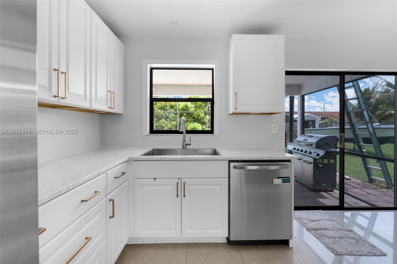 16040 Southwest 287th Street Homestead, FL 33033 - Photo 9 of 48 a kitchen with stainless steel appliances granite countertop a sink and a stove