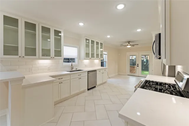 a large white kitchen with a large window