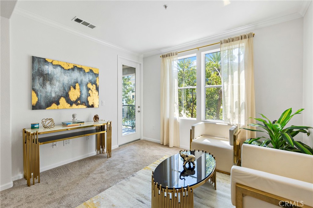 a living room with furniture and window with wooden floor