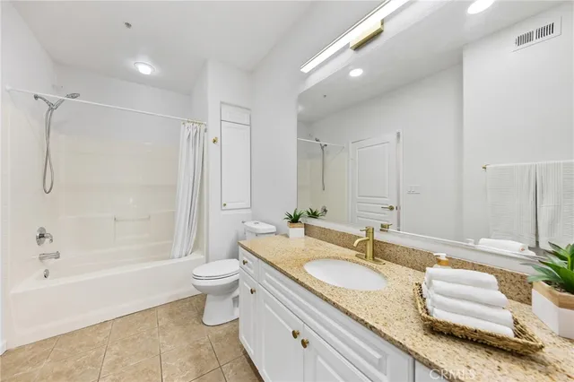 a spacious bathroom with a granite countertop tub sink and mirror