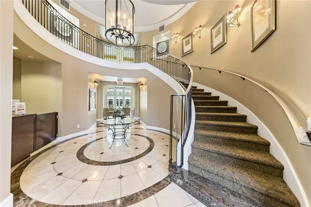 a living room with fireplace furniture and a chandelier