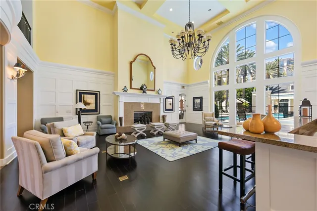 a living room with fireplace furniture and a chandelier