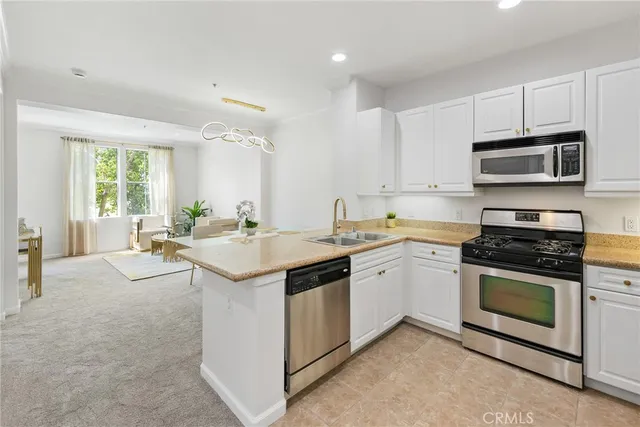 a kitchen with a sink stove and microwave