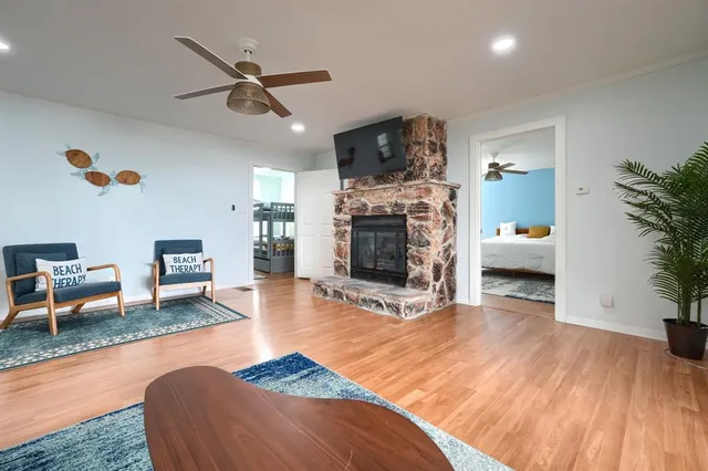 a living room with furniture and a wooden floor