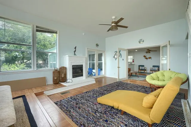 a living room with couch guitar and a fireplace