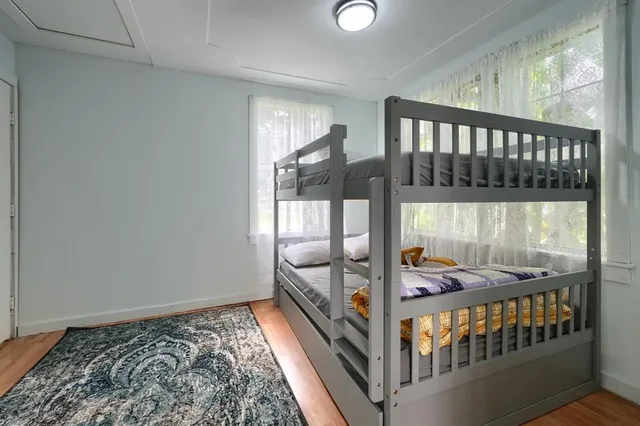 a bedroom with a bed a couch and a window