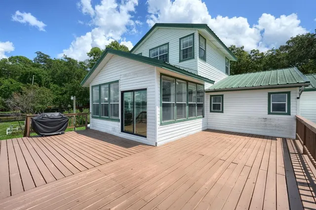 a front view of house with backyard and green space