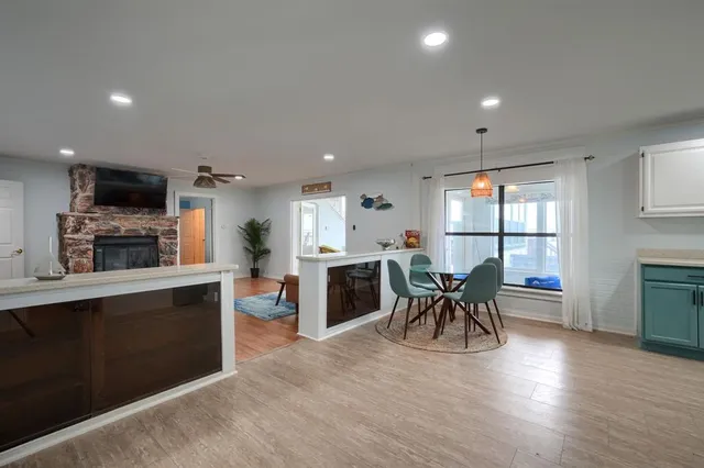 a kitchen with a table chairs a sink dishwasher and cabinets