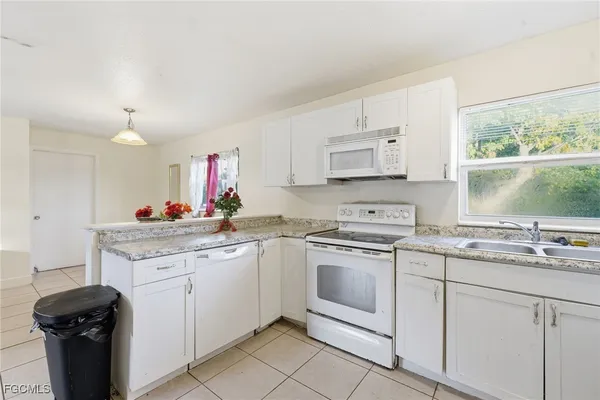 a kitchen with a sink stove and cabinets