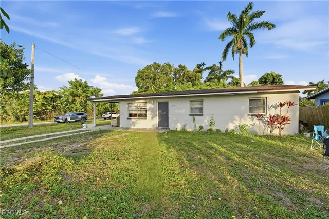 a view of a house with a yard and a garden