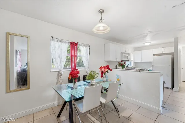 a view of a dining room with furniture and a chandelier
