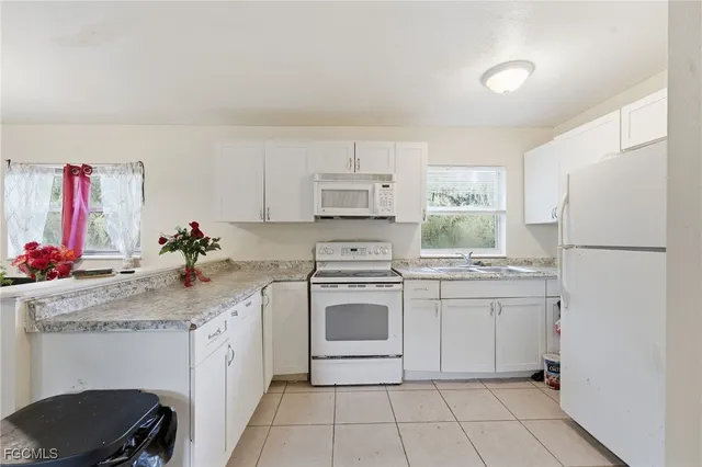 a kitchen with a sink cabinets and appliances